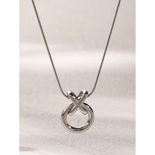 Silver stainless steel necklace with a XO unique pendant on a light background