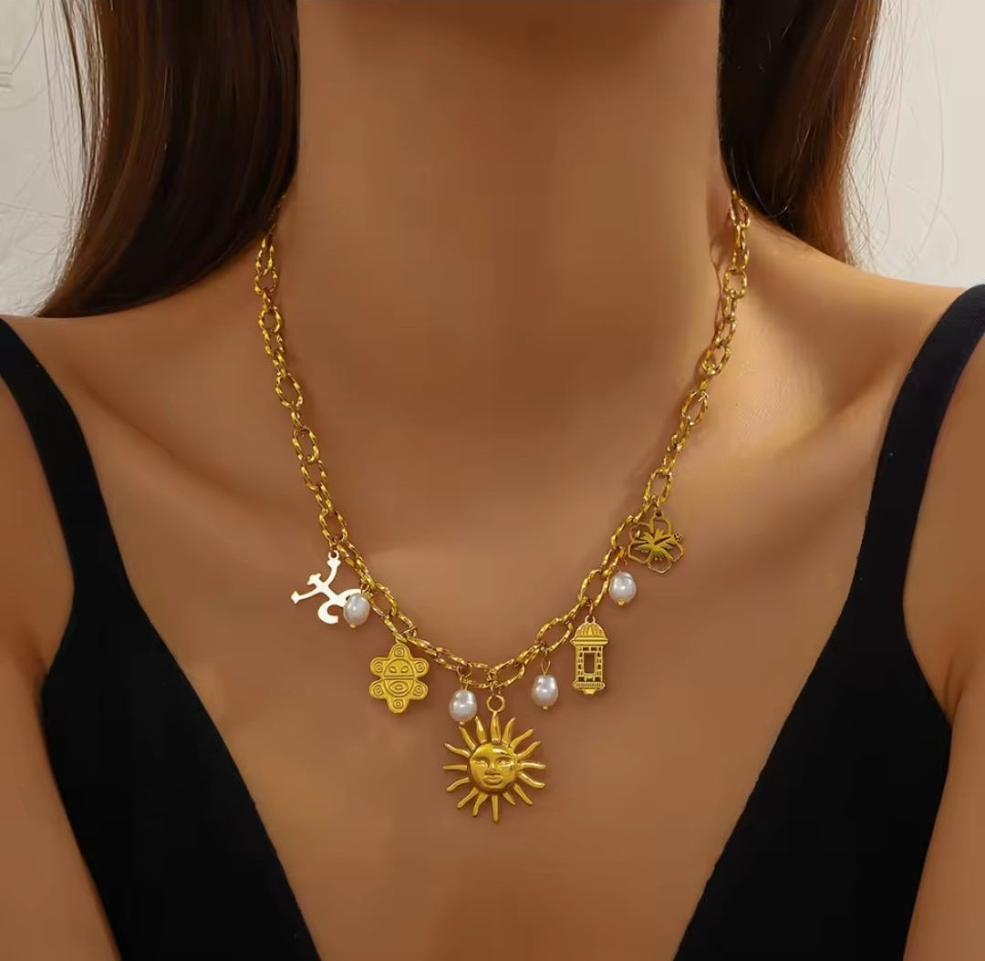 Model wearing Elyse stainless steel charm necklace styled at the collarbone