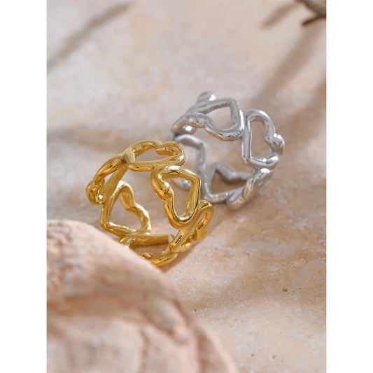 Gold and silver rings on a beige surface