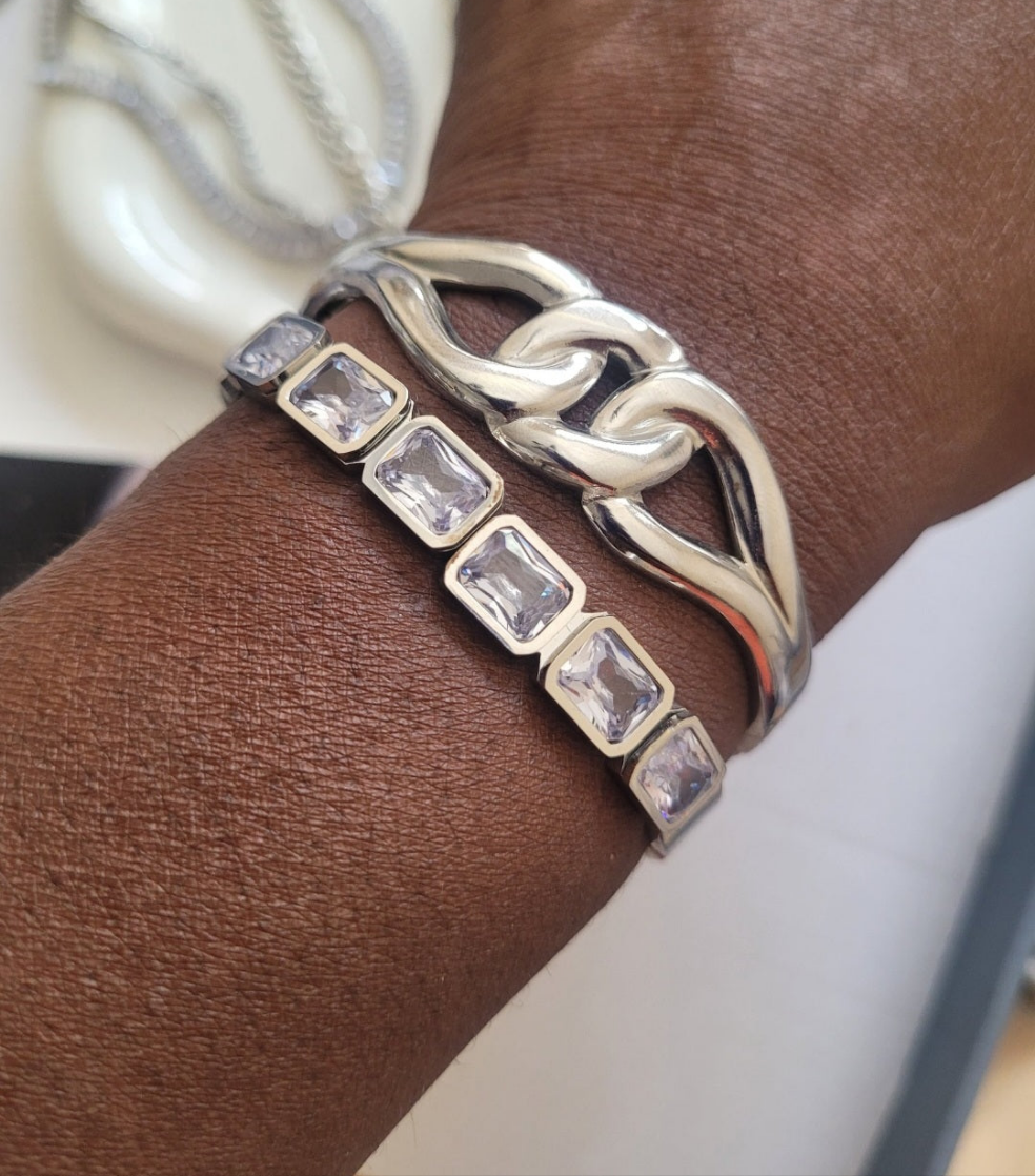 Silver bracelet with rectangular gemstones on a wrist