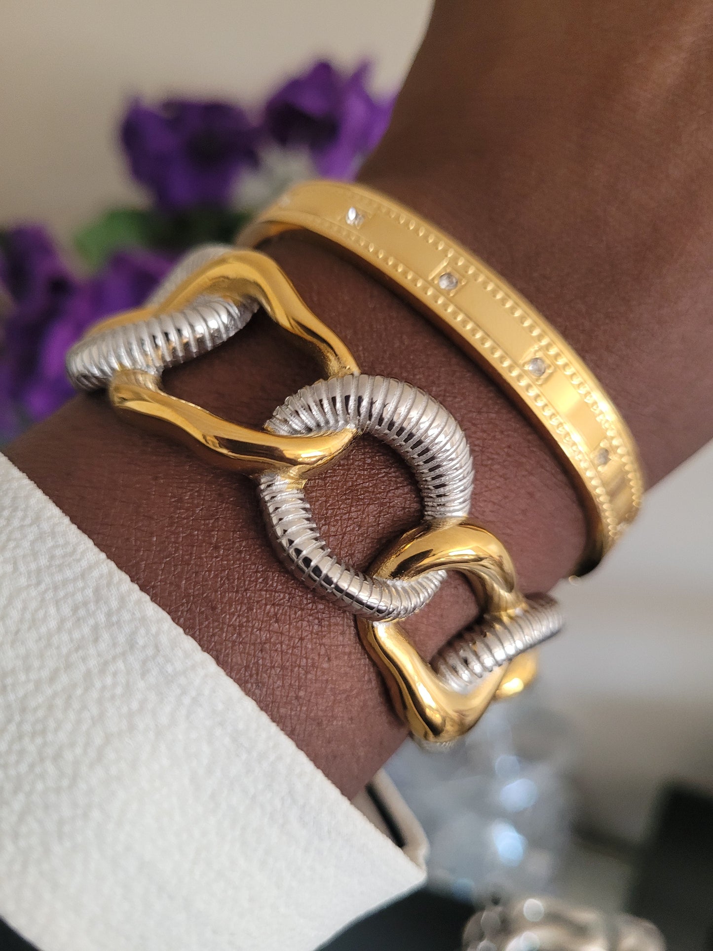 Gold and silver bracelet on a wrist
