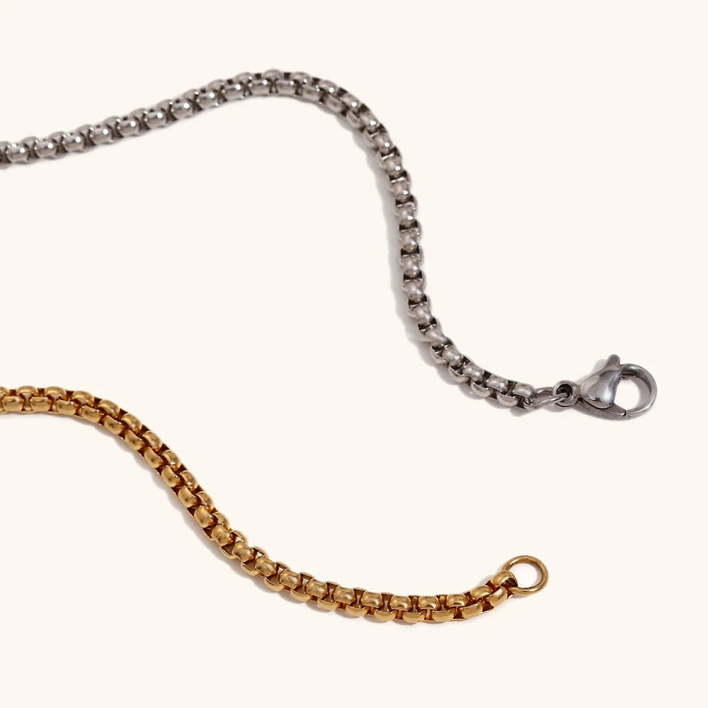 Close-up of the necklace chain, highlighting the distinctive square link design and the high-polish finish.