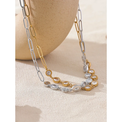 Elegant gold pendant necklace laying beside a jewellery box — 18k gold Carmina necklace