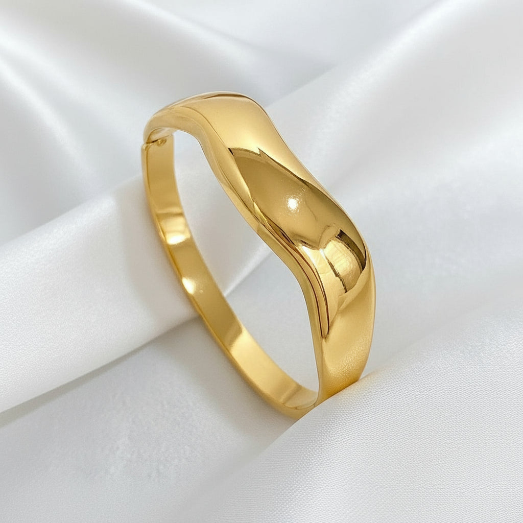 Fashion Gold bracelet on a beige fabric background