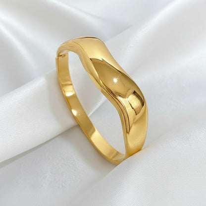 Fashion Gold bracelet on a beige fabric background