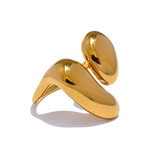 Gold chunky statement ring with wide band on a white background