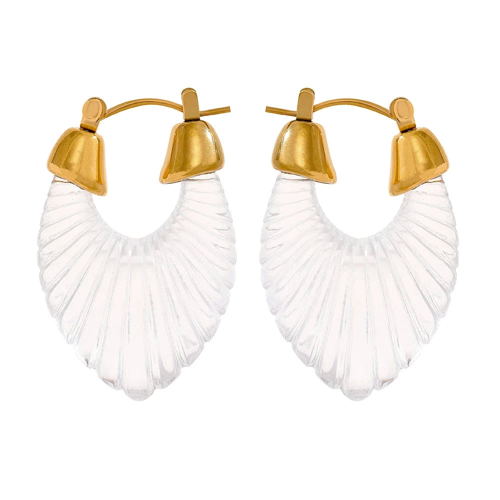 Pair of earrings with gold hooks and white fan-shaped drops on a white background