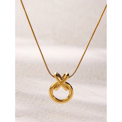  XO pendant necklace in gold, hanging from a snake chain link.