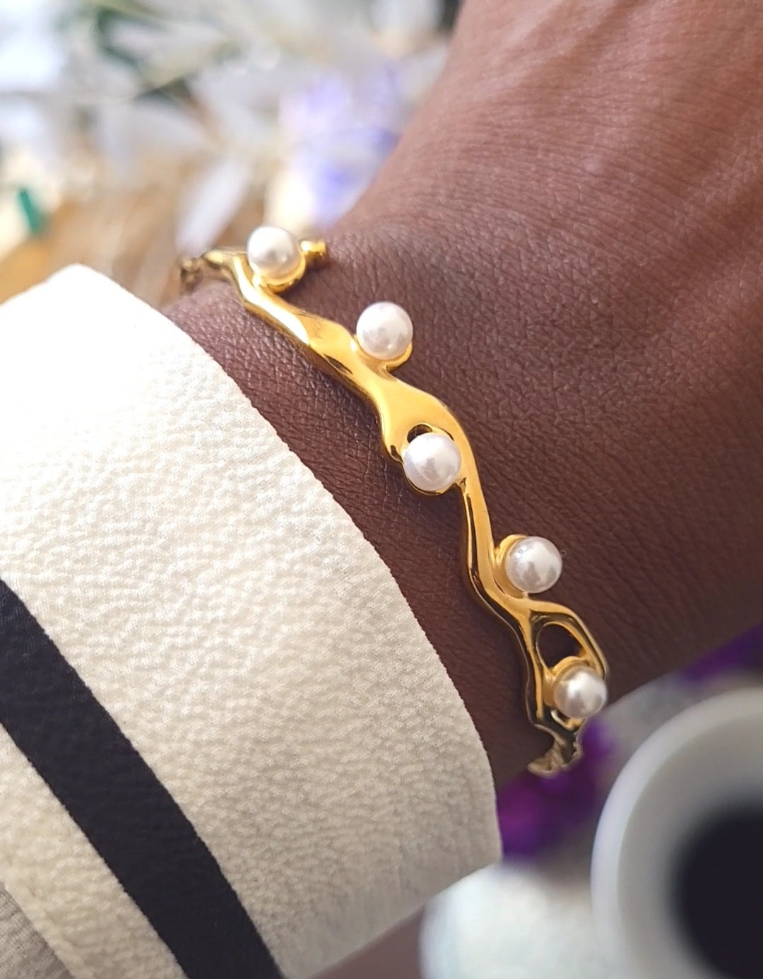 Close-up of Aurelian Pearl Cuff showing stainless steel base and pearl detailing