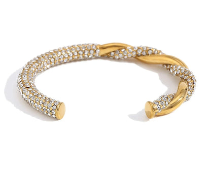 Gold bracelet with crystal embellishments on a white background