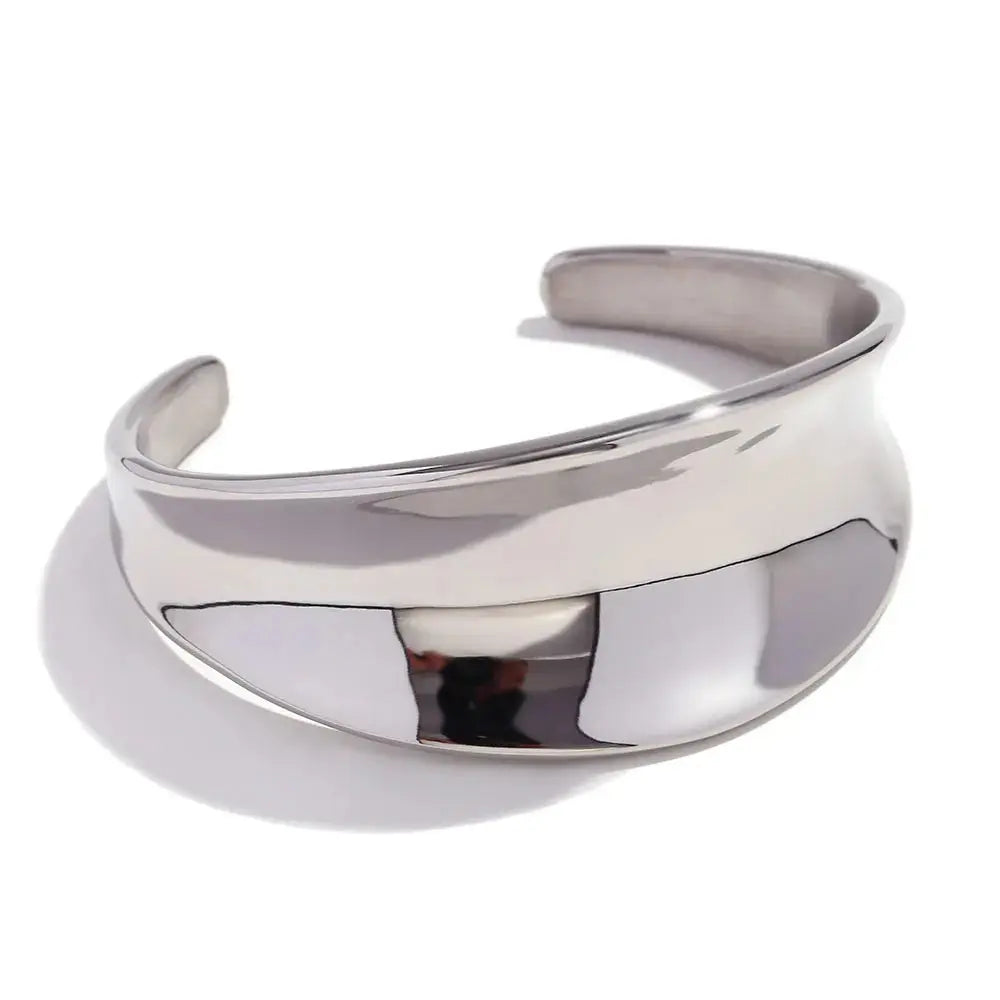 Tarnish-free, water-resistant silver concave cuff bracelet. Highlights its hypoallergenic and eco-friendly stainless steel construction.