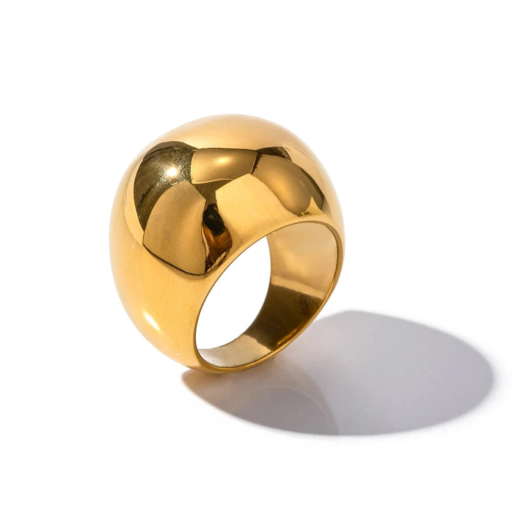 Gold ring with geometric design on a white background