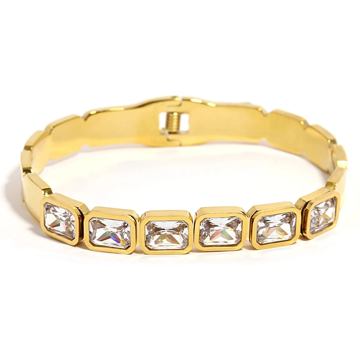 Gold bracelet with clear gemstones on a white background