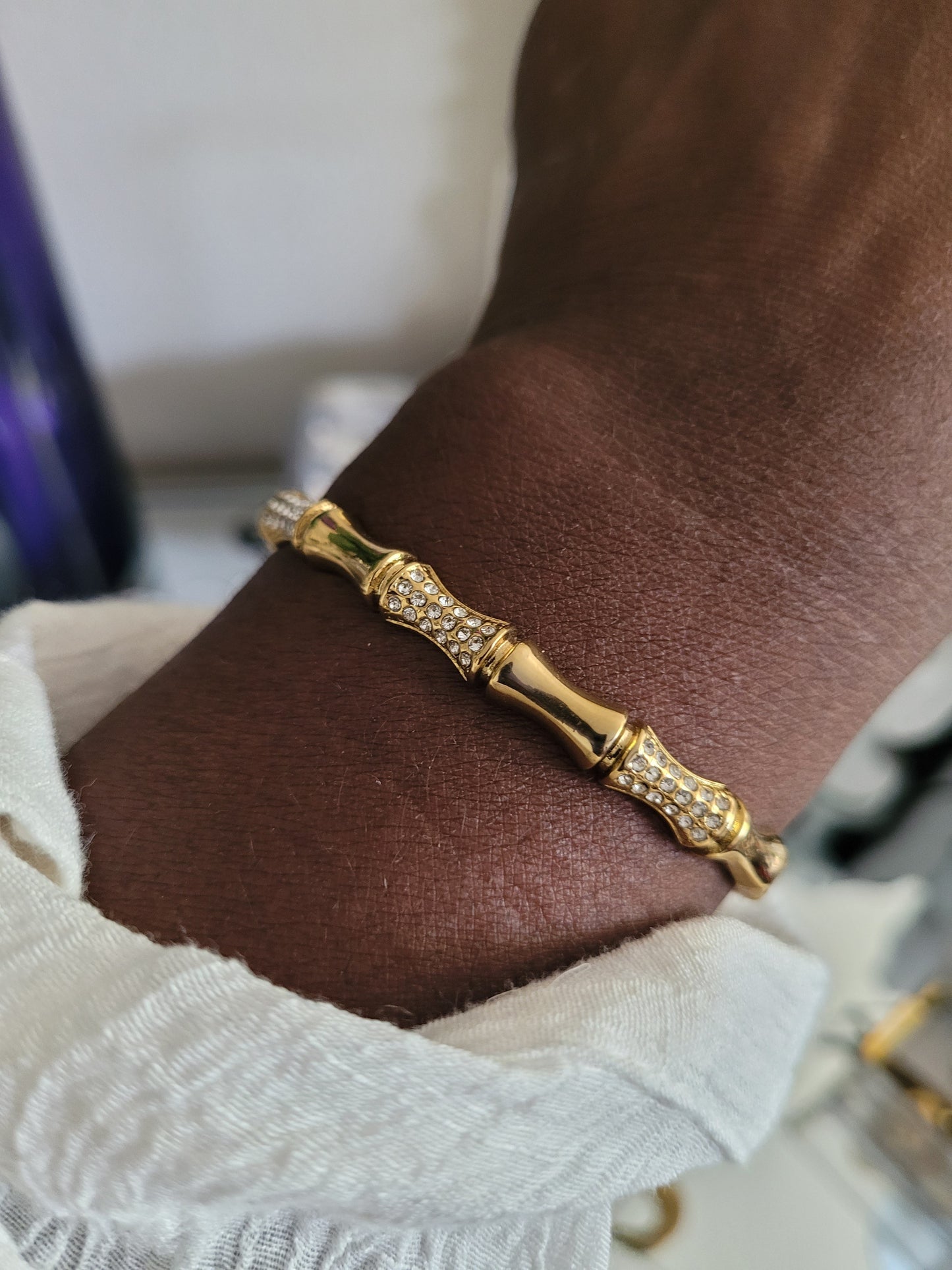 Gold bracelet on a a model's wrist. Watrerproof,Hypoallergenic