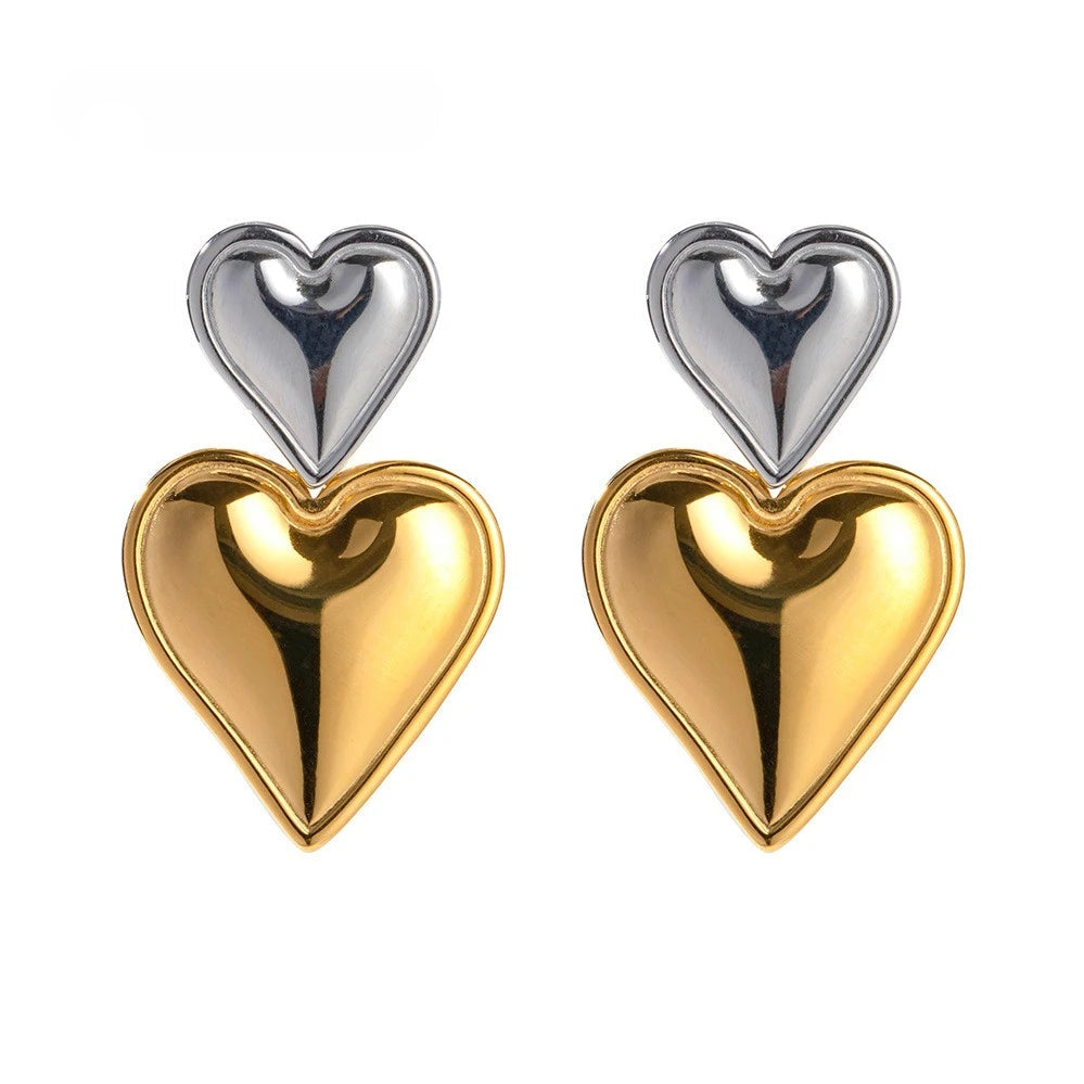 Heart-shaped earrings with gold and silver hearts on a white background.