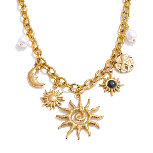 A gold-colored stainless steel pendant charm necklace with star, moon, and sun shaped pendants, and white simulated pearl elements on a chain.