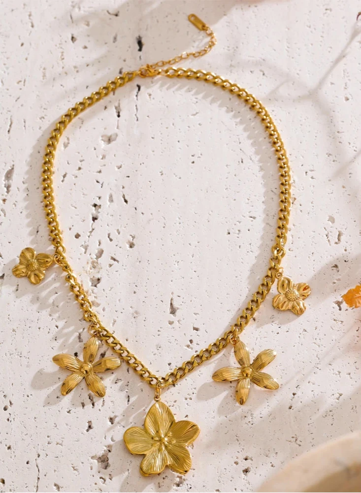 Golden Flower Drop Charm Necklace Your new everyday essential. This water-resistant, tarnish-free Golden Flower Charm Necklace is made from hypoallergenic stainless steel, blending durability with delicate style.
