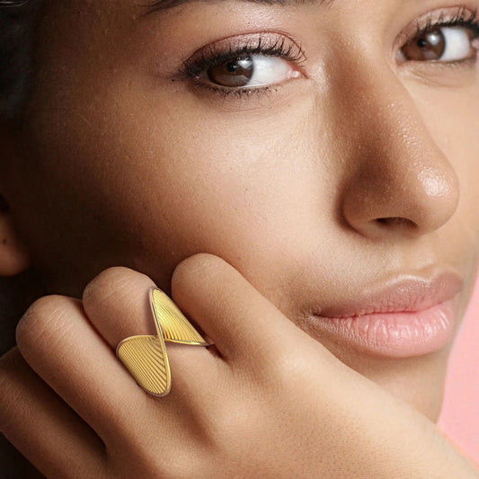 Waterproof statement dome ring Close-up of a woman wearing a 18k PVD gold-plated ring on her finger