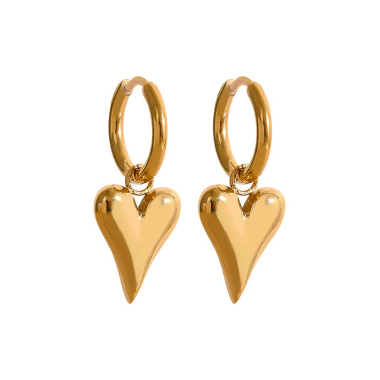 Close-up of PVD gold-tone stainless steel huggie hoop earrings with a heart design on a white background.