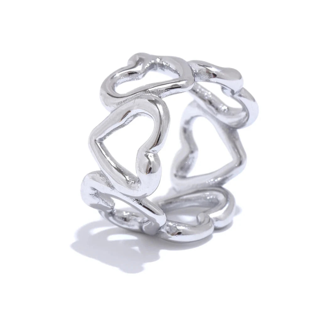 Silver ring with heart designs on a white background