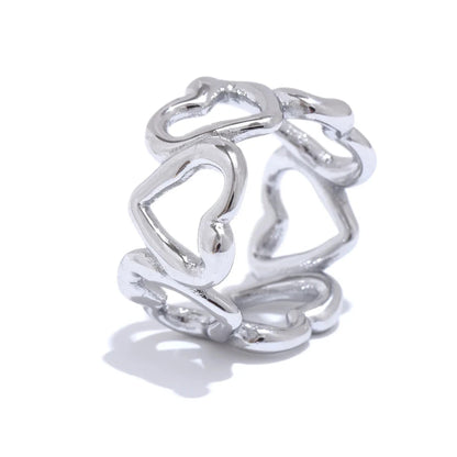 Silver ring with heart designs on a white background