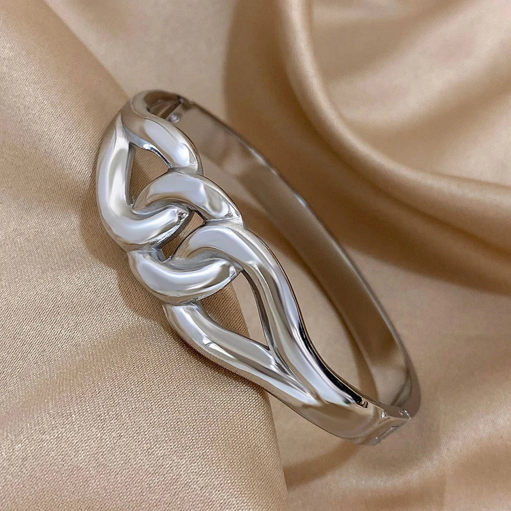 Silver bracelet on a beige satin background