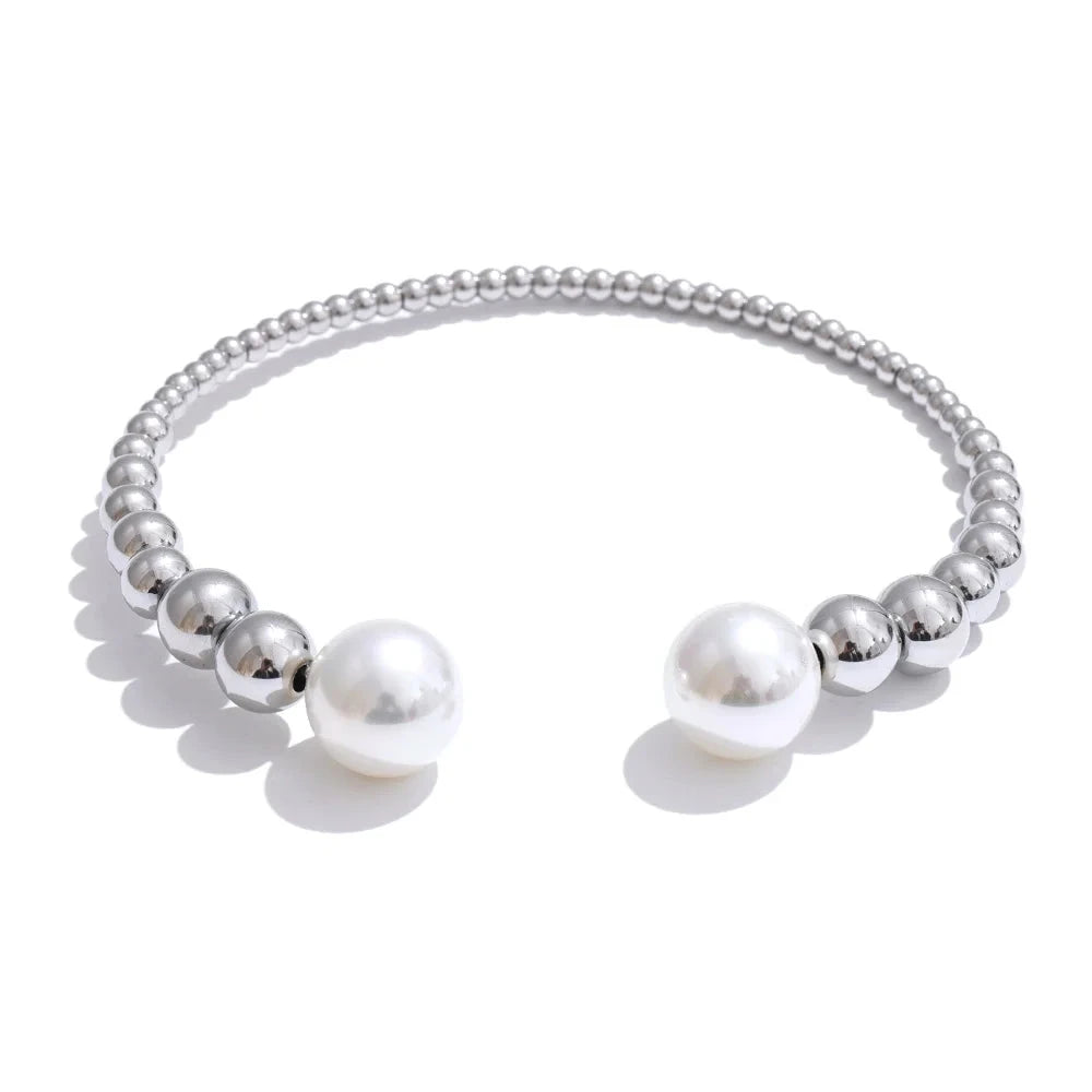 Silver bracelet with pearls on a white background