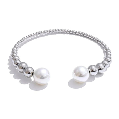 Silver bracelet with pearls on a white background