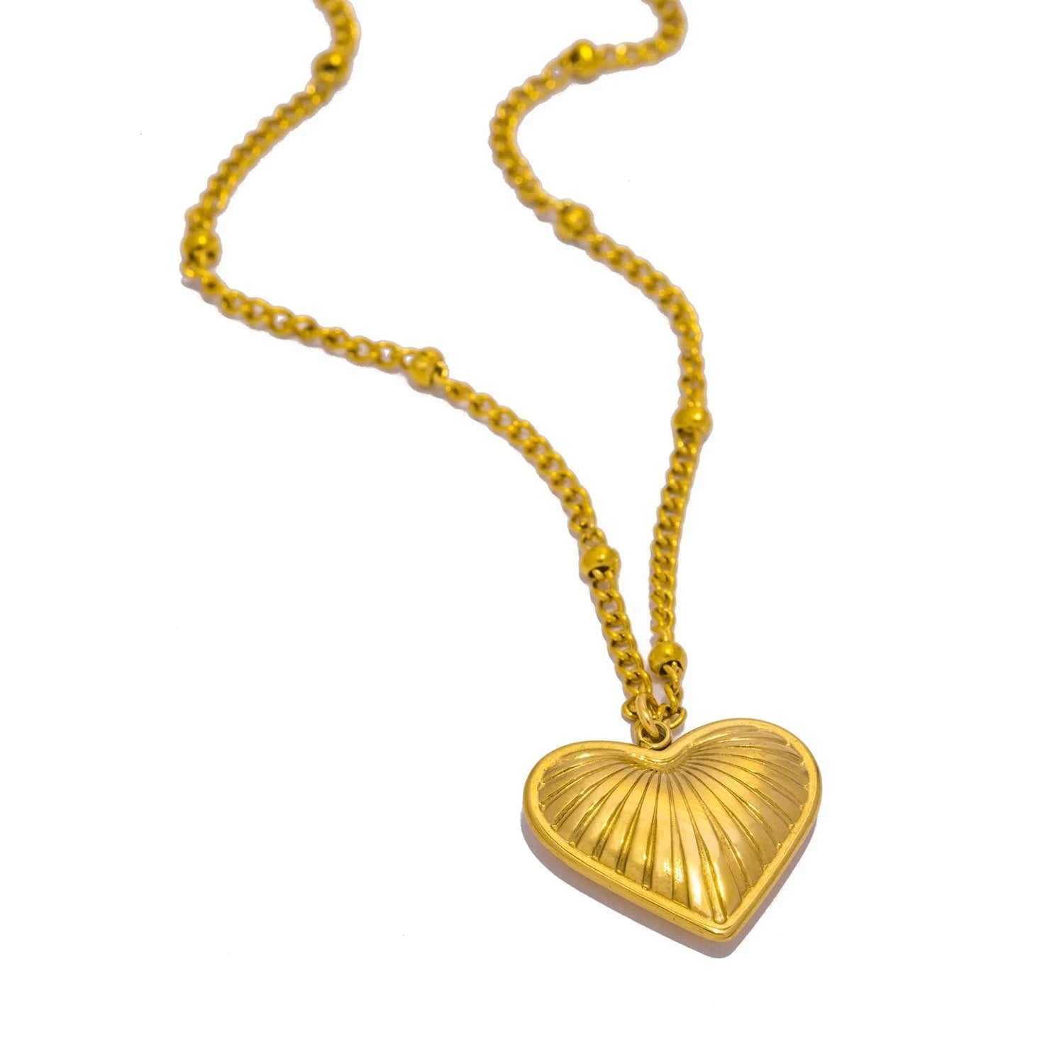 Gold heart-shaped pendant necklace on a white background