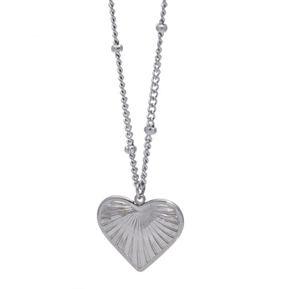 Silver heart-shaped pendant necklace on a white background