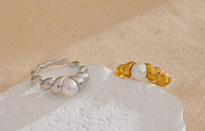 Close-up of the ring's gold-plated twisted band, emphasizing the texture and the setting of the simulated-pearl.
