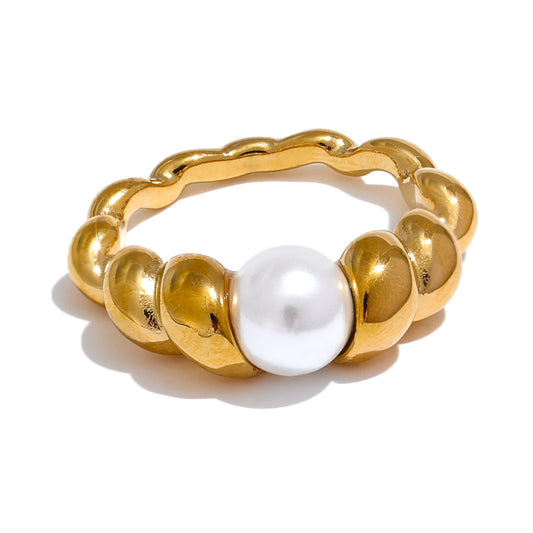 Mika Twisted Pearl Ring in Gold, featuring a central simulated-pearl nestled on a detailed twisted band against a white background.