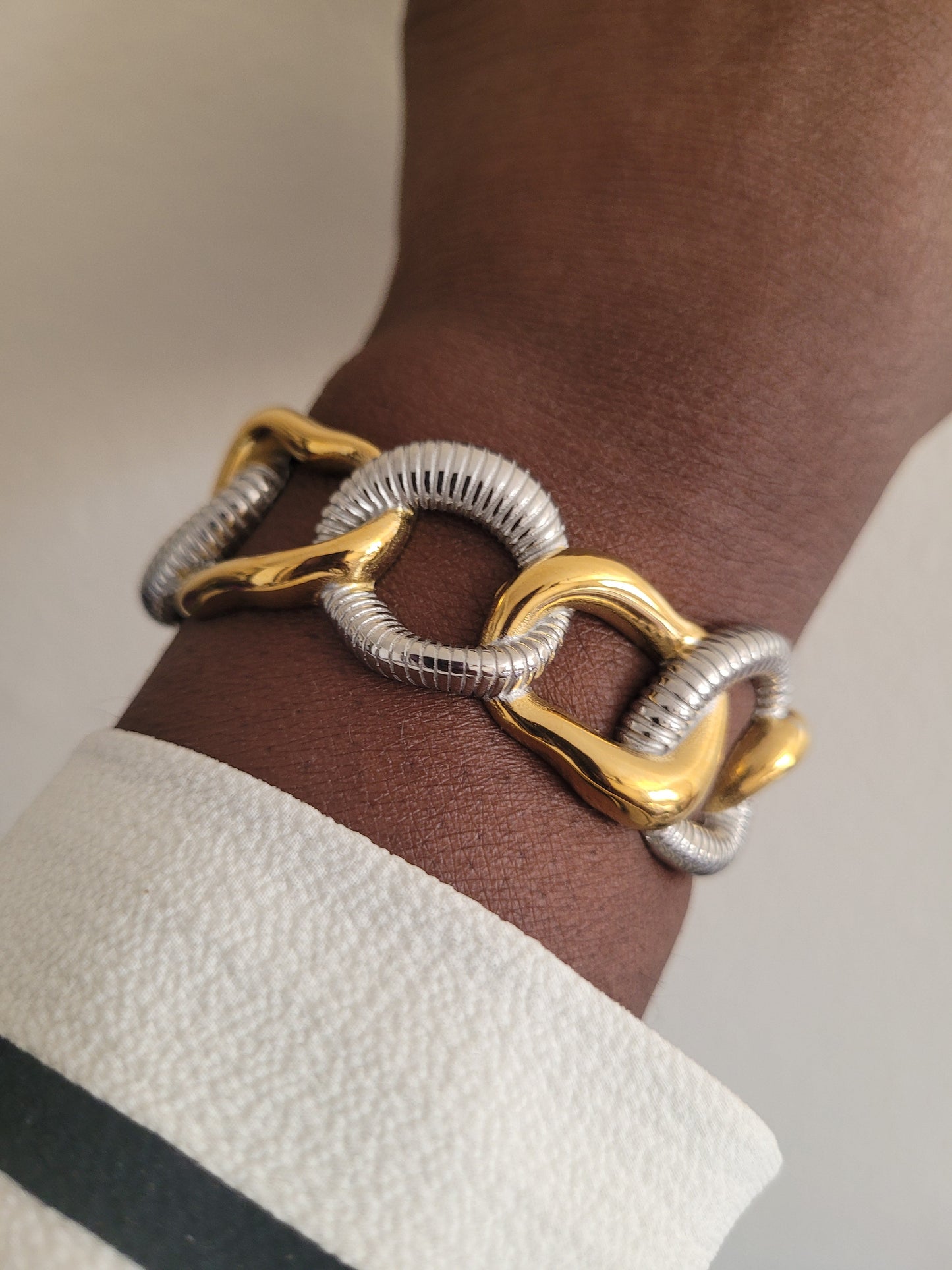 Exaggerated Cuff Bracelet worn on a model's wrist, demonstrating the large scale and striking appearance of the cuff.