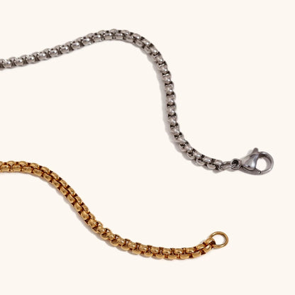 Close-up of the necklace chain, highlighting the distinctive square link design and the high-polish finish.