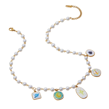 Astro Charm Necklace displayed flat with freshwater pearls and 18k gold-plated stainless steel star charm.”