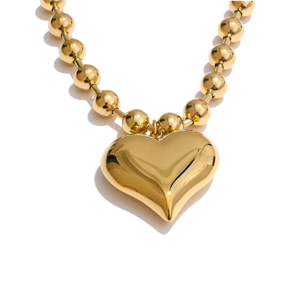 Gold heart-shaped pendant necklace on a white background 