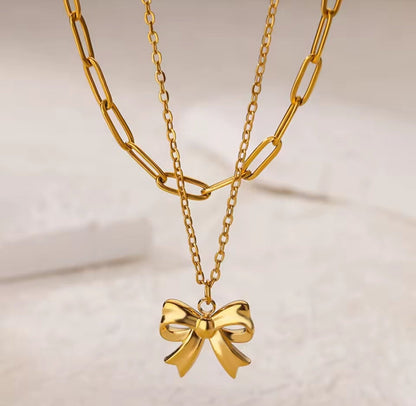 Fashion jewelry gold chain necklace with a bow pendant 