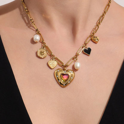 Gold necklace with heart-shaped pendant and various charms