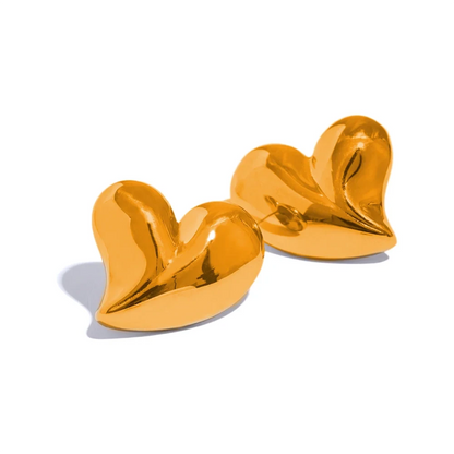 Gold heart-shaped earrings on a white background