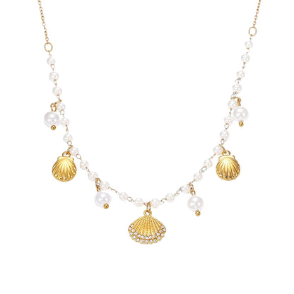Necklace with gold shell pendants and white beads on a white background, featuring the Inti Jewelry brand.
