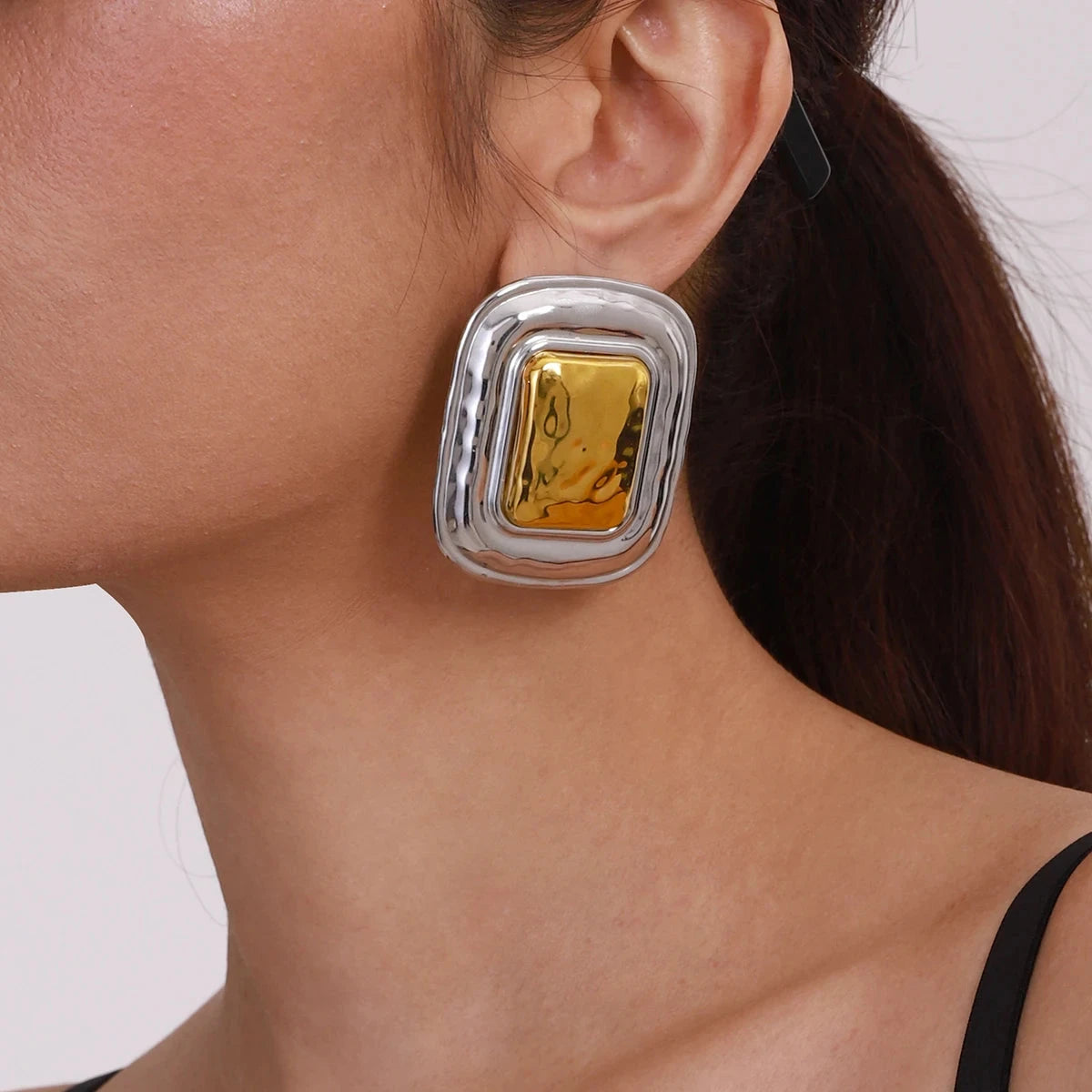 Veronica Mixed Metal Earrings Oversized Veronica Mixed Metal Earrings with a bold, modern square design, featuring silver and gold tones.