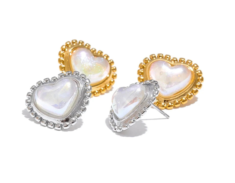 Heart-shaped earrings with gold and silver frames on a white background