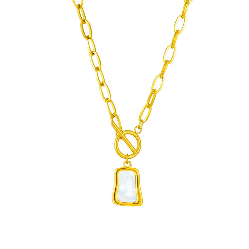 Zena Pendant Necklace in gold-toned 316L stainless steel, featuring a geometric trapezoidal pendant and a dangling pearl oyster charm.